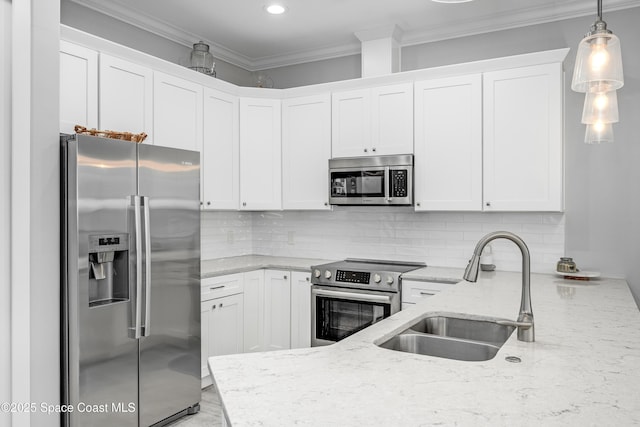 kitchen with sink, hanging light fixtures, light stone counters, white cabinets, and appliances with stainless steel finishes