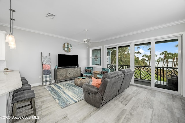 living room featuring ceiling fan, crown molding, and light hardwood / wood-style flooring