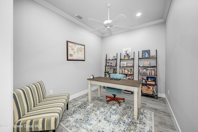 office area with light wood-type flooring, ceiling fan, and crown molding