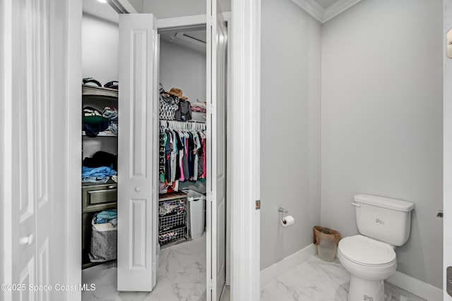 bathroom with crown molding and toilet