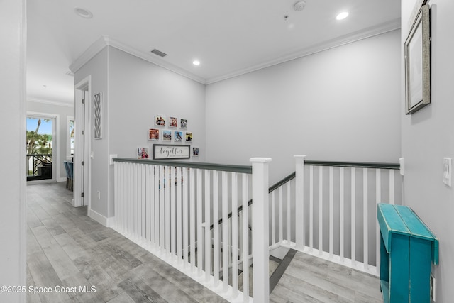 corridor featuring light hardwood / wood-style flooring and crown molding