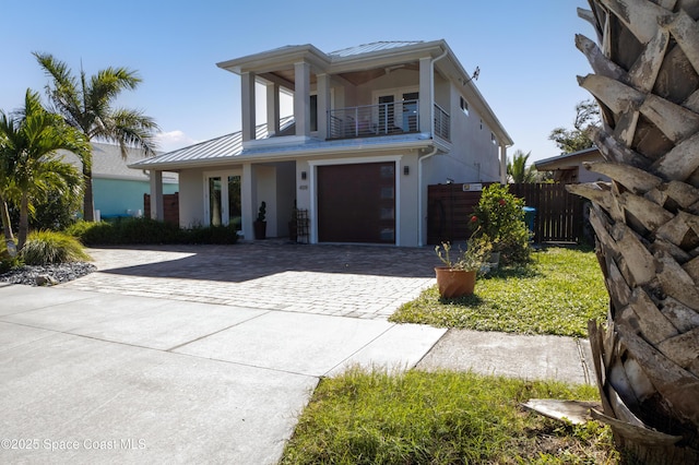 view of front facade featuring a balcony and a garage