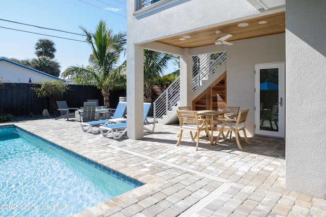 view of pool featuring ceiling fan and a patio area