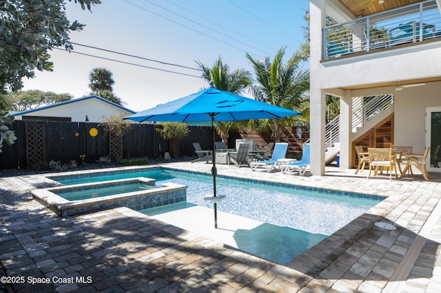 view of swimming pool featuring an in ground hot tub and a patio