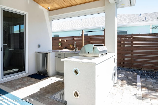 view of patio / terrace featuring area for grilling and sink