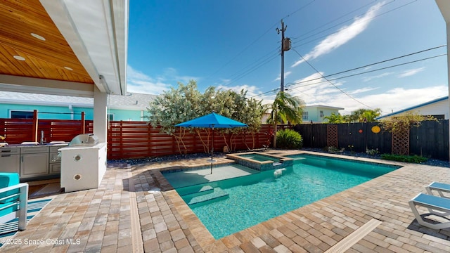 view of pool with an in ground hot tub and a patio area