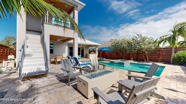 view of swimming pool with an in ground hot tub and a patio