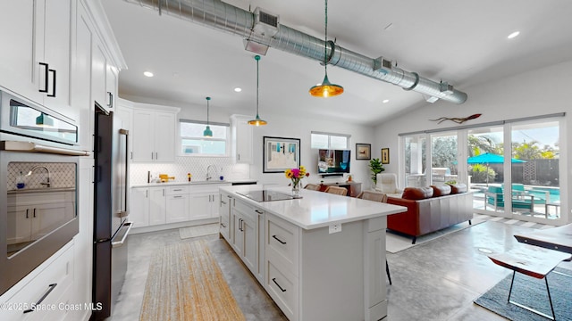 kitchen with decorative backsplash, white cabinetry, a center island, and pendant lighting