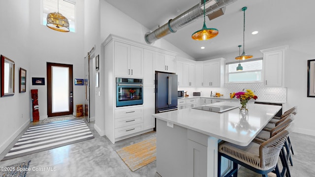 kitchen featuring a center island, stainless steel appliances, and white cabinetry