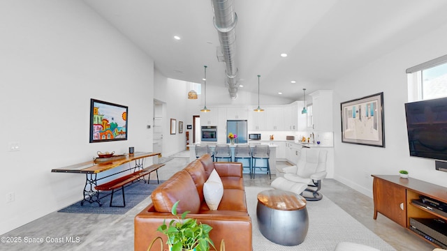 living room featuring high vaulted ceiling and sink