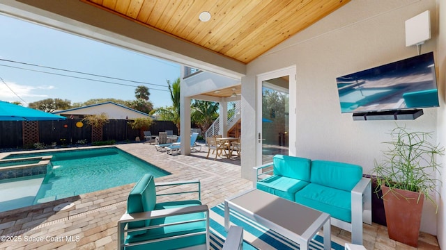 view of swimming pool with outdoor lounge area, an in ground hot tub, and a patio