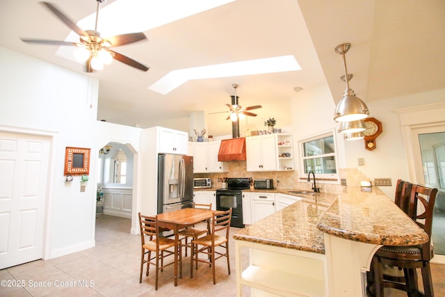 kitchen with kitchen peninsula, white cabinets, sink, and black electric range oven