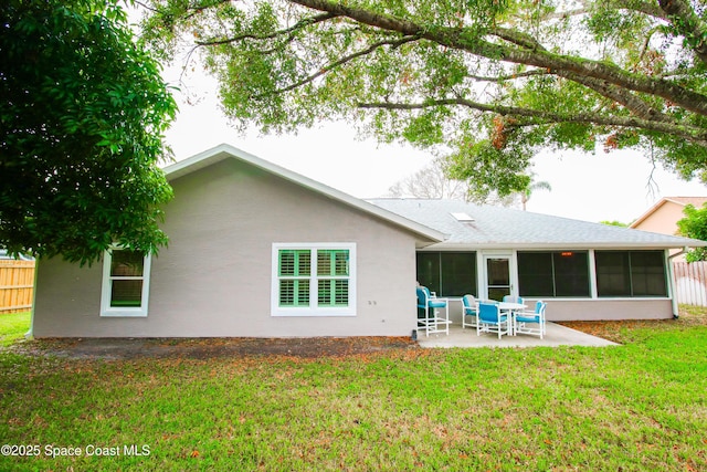 back of house with a patio, a lawn, and a sunroom