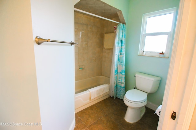 bathroom featuring toilet, shower / bath combo with shower curtain, and tile patterned flooring