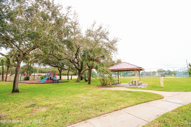 view of property's community with a gazebo, a playground, and a lawn