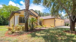 mediterranean / spanish home with a garage and a front yard