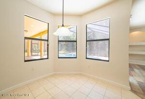 unfurnished dining area with tile patterned flooring