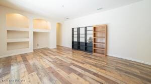 unfurnished living room featuring wood-type flooring