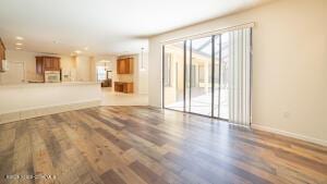 unfurnished living room with dark hardwood / wood-style flooring