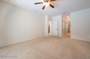 unfurnished room with ceiling fan and carpet