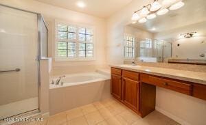 bathroom with vanity, tile patterned floors, and shower with separate bathtub