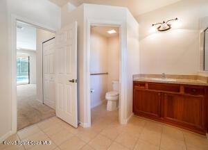 bathroom with vanity, toilet, and tile patterned floors