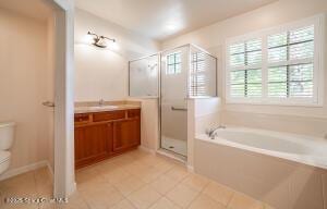 full bathroom featuring plus walk in shower, toilet, tile patterned floors, and vanity