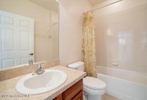 full bathroom featuring toilet, shower / tub combo with curtain, and vanity