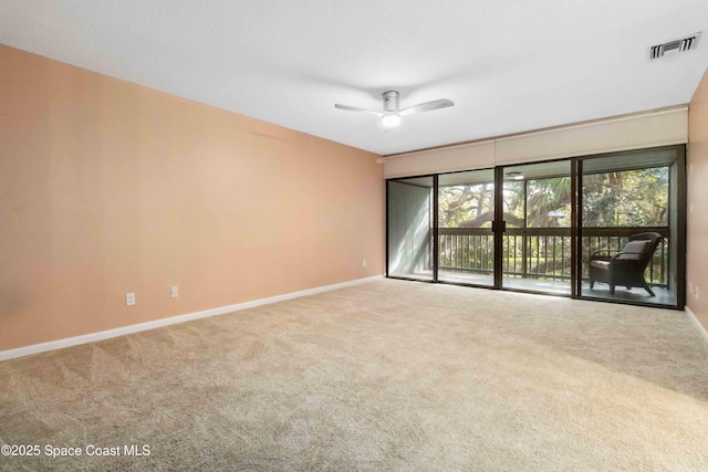 spare room with carpet and ceiling fan