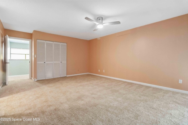 unfurnished bedroom with a closet, light colored carpet, and ceiling fan