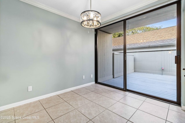 tiled empty room featuring an inviting chandelier and ornamental molding