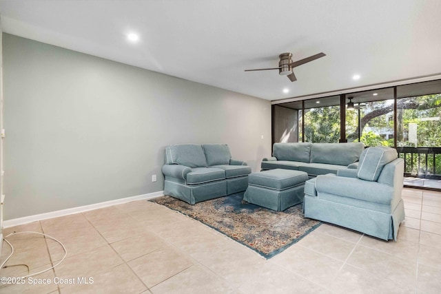 tiled living room with a wall of windows and ceiling fan