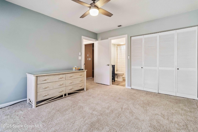 unfurnished bedroom with ensuite bath, ceiling fan, a closet, and light carpet