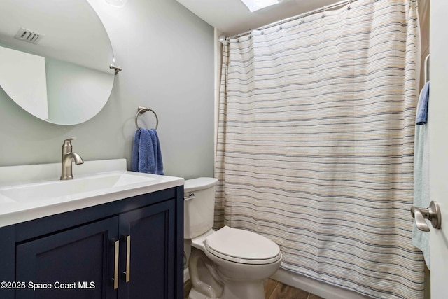 bathroom featuring hardwood / wood-style flooring, vanity, toilet, and a shower with curtain