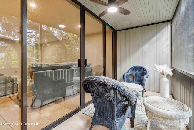 sunroom with ceiling fan and wooden ceiling