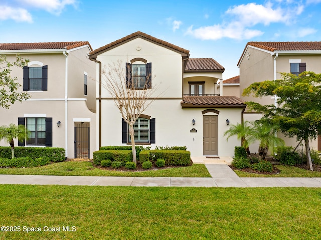 mediterranean / spanish-style home with a front yard