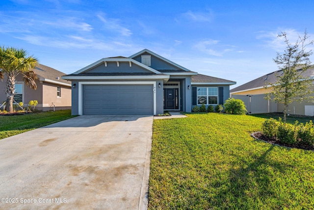 view of front of home with a front yard and a garage