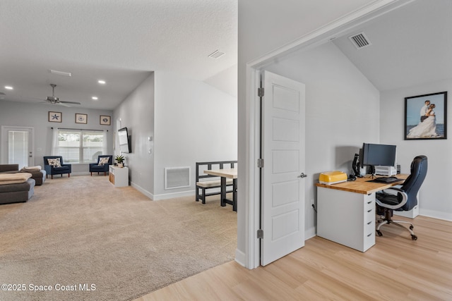 office area with a textured ceiling, ceiling fan, lofted ceiling, and light wood-type flooring