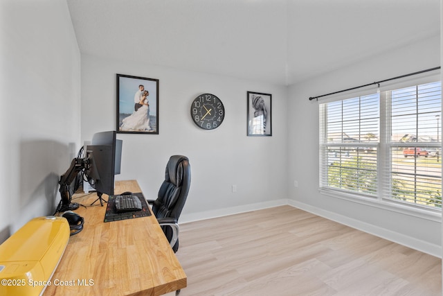 office space with light wood-type flooring and lofted ceiling