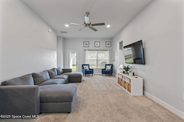 carpeted living room with ceiling fan