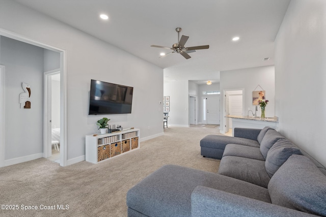 carpeted living room with ceiling fan