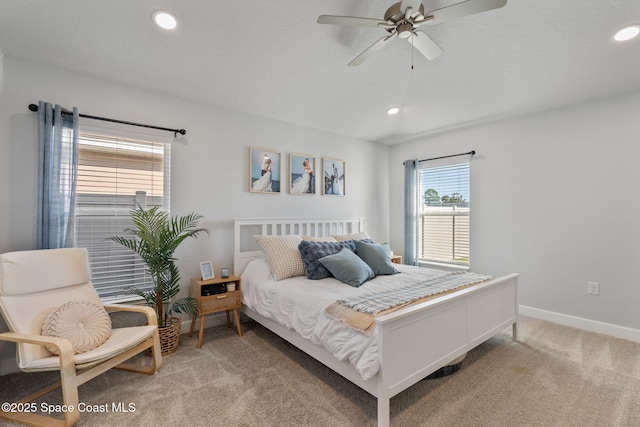 bedroom with ceiling fan and light carpet