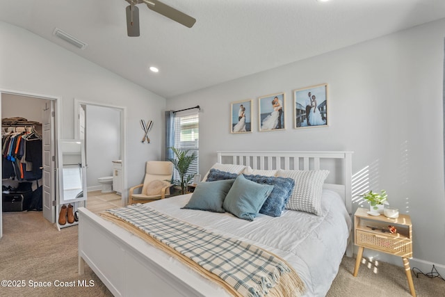 carpeted bedroom featuring ensuite bathroom, ceiling fan, a spacious closet, a closet, and lofted ceiling