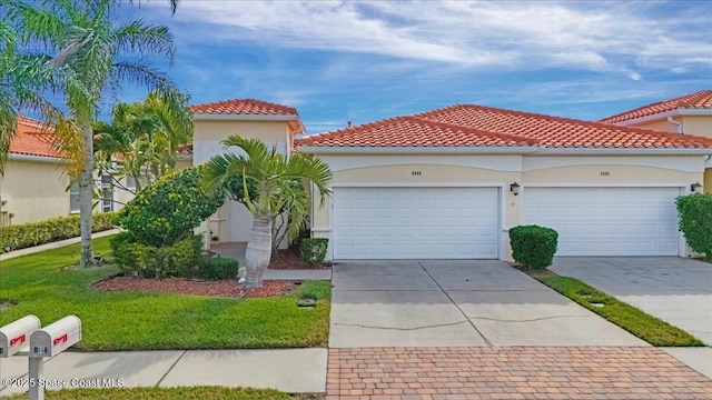 mediterranean / spanish-style house with a front yard and a garage