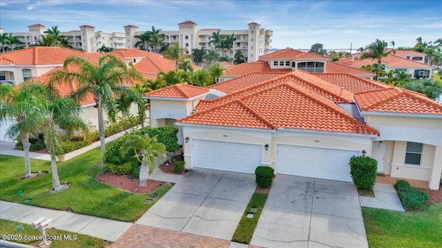 mediterranean / spanish-style house featuring a front lawn and a garage