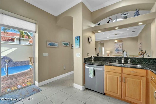 kitchen with dishwasher, sink, hanging light fixtures, dark stone countertops, and ornamental molding