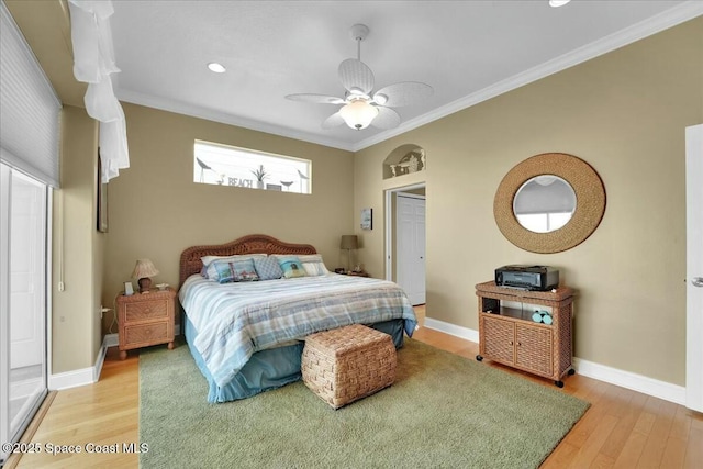 bedroom featuring ceiling fan, hardwood / wood-style floors, and crown molding