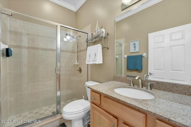 bathroom with toilet, vanity, ornamental molding, and walk in shower