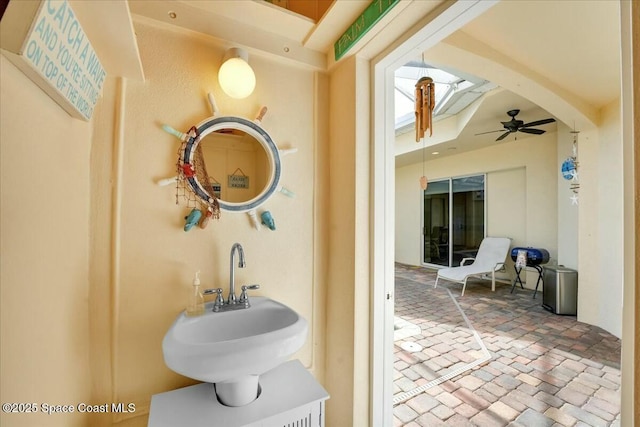 bathroom featuring ceiling fan and sink