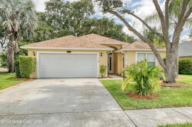 view of front of home with a garage and a front lawn